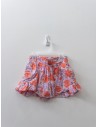 short rosado con flores rojas